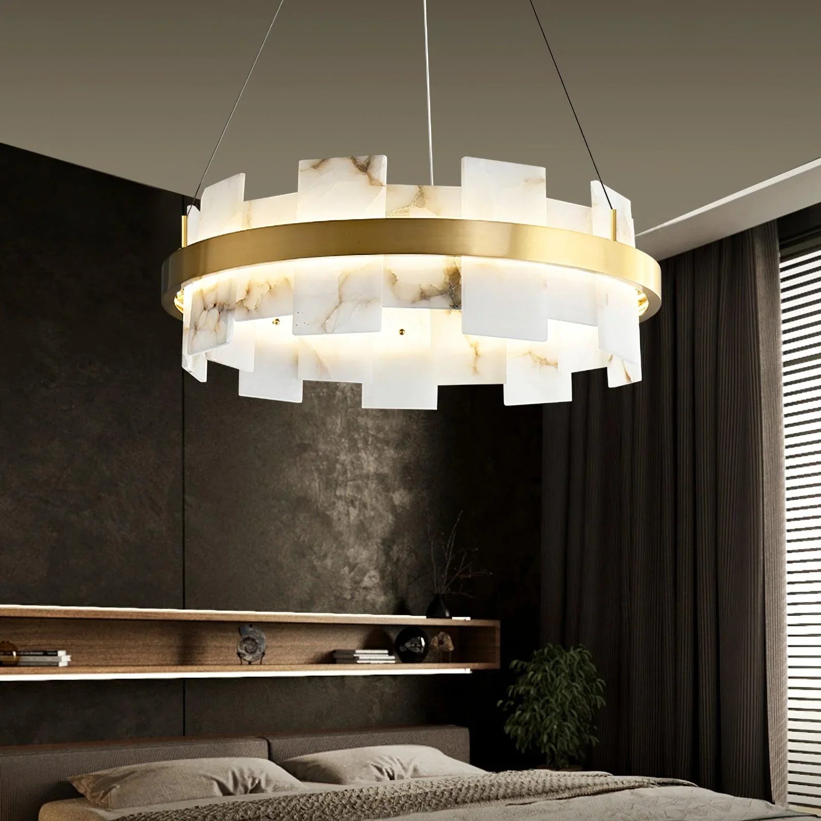 Modern brass and alabaster pendant chandelier above a stylish bedroom, YH Lamps designer lighting
