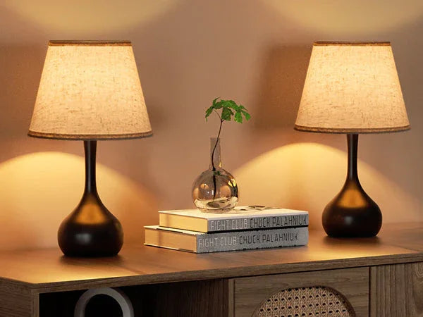 Pair of modern table lamps with beige shades on a wooden surface, YH Lamps designer lighting