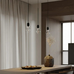 Modern pendant lights over a dining table with minimalist decor at YH Lamps