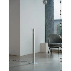 Modern minimalist floor lamp with silver finish in a contemporary living room