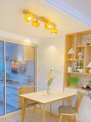 Modern pumpkin-shaped yellow ceiling lamp with wood accent in a bright dining area at YH Lamps