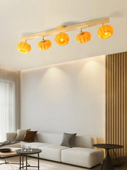 Modern living room with YH Lamps ceiling fixture, yellow pumpkin-shaped lampshades, wood mount