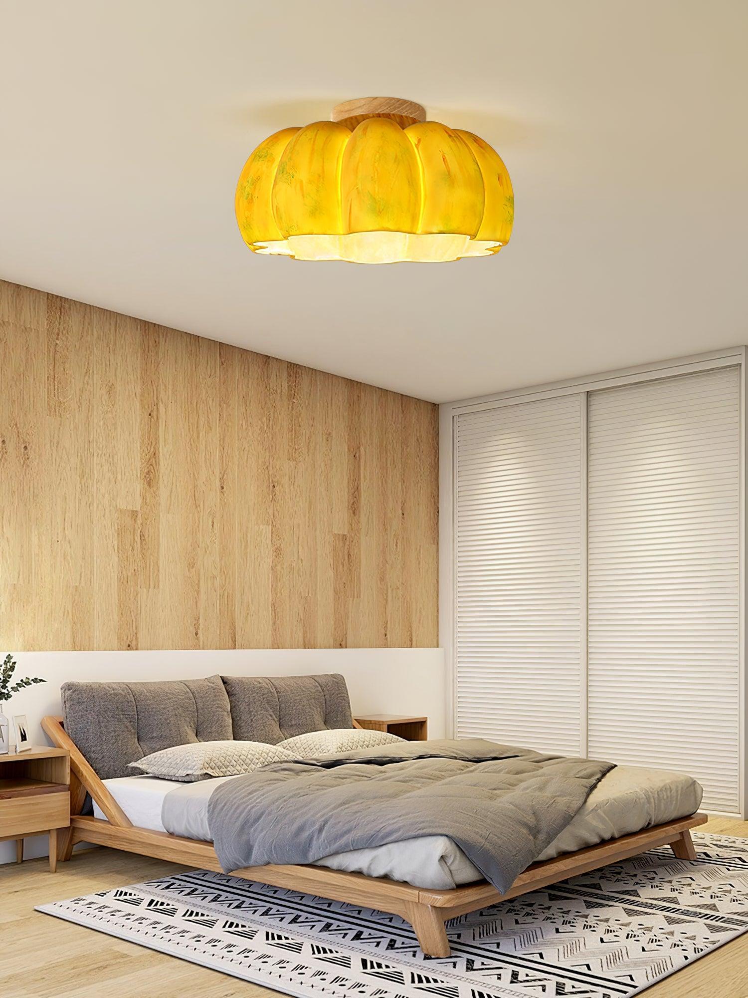 Yellow pumpkin-shaped ceiling light in a modern bedroom with wood accents by YH Lamps