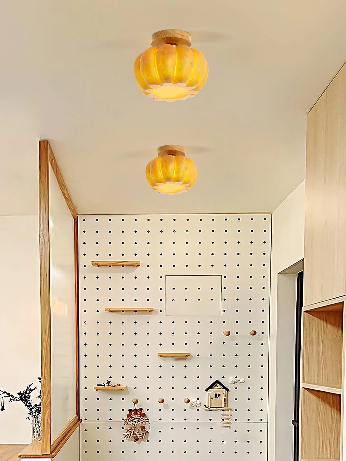 Modern yellow pumpkin ceiling lamps with wood accents in a stylish, minimal home interior
