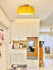 Yellow pumpkin-shaped ceiling lamp in modern entryway with white built-ins, from YH Lamps