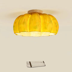 Yellow pumpkin-shaped ceiling lamp with wood accent above modern sofa, YH Lamps lighting