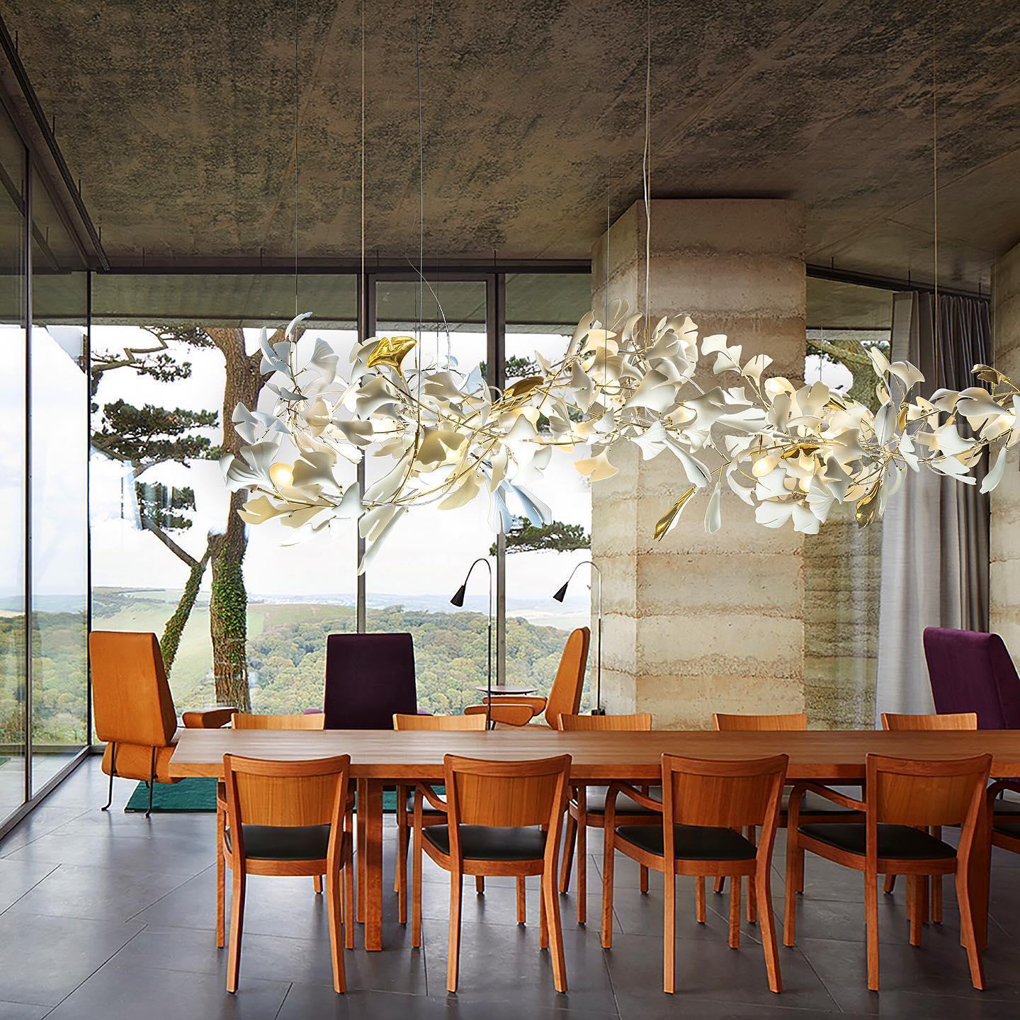 Modern dining room with large wooden table, wooden chairs, and gold white ginkgo chandelier from YH Lamps