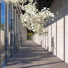 Modern hallway with large floor-to-ceiling windows and a white gingko leaf chandelier in gold and white