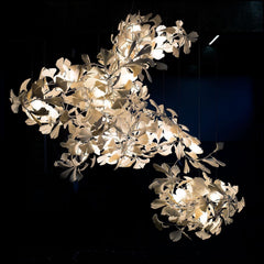 Modern gold and white gingko leaf chandelier with multiple light bulbs, elegant home lighting fixture