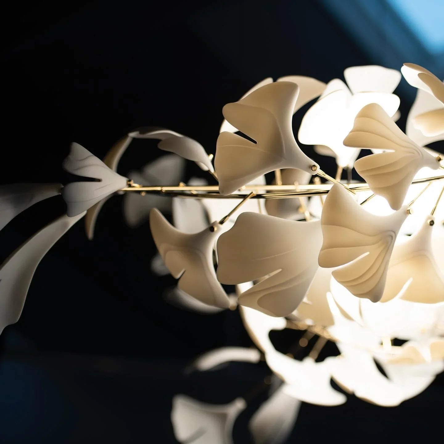 Modern gold and white gingko leaf chandelier with soft glowing lights by YH Lamps