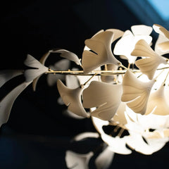 Modern gold and white gingko leaf chandelier with soft glowing lights by YH Lamps