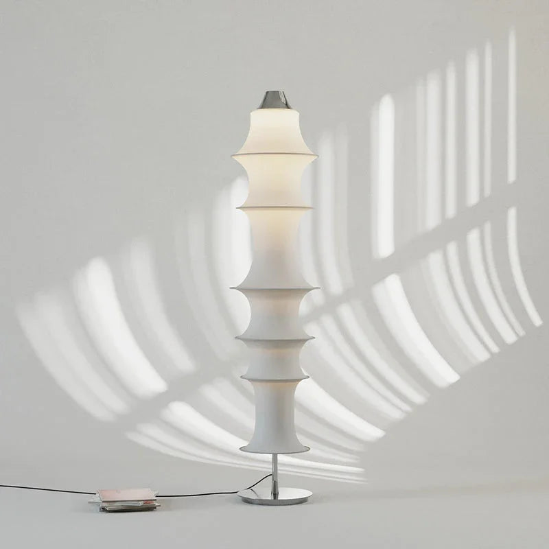 Modern white elastic fabric floor lamp with sculptural design in minimalist room