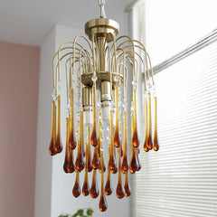 Modern brass chandelier pendant lamp with amber maltose glass drops and crystal accents, stylish home lighting