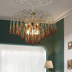 Modern brass chandelier pendant lamp with amber glass drops hanging in elegant living room
