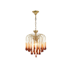Modern brass chandelier pendant lamp with multiple amber glass droplet accents hanging from curved arms