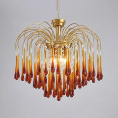 Elegant modern chandelier with brass frame and amber maltose glass drops, illuminated pendant light