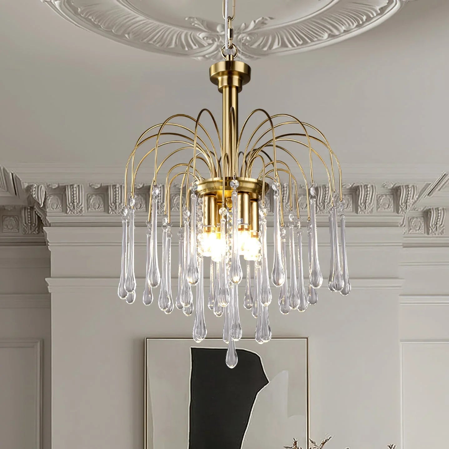 Modern brass chandelier pendant lamp with clear maltose glass droplets hanging in elegant room