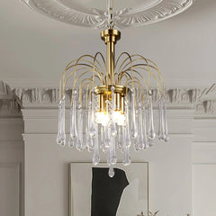 Modern brass chandelier pendant lamp with clear maltose glass droplets hanging in elegant room