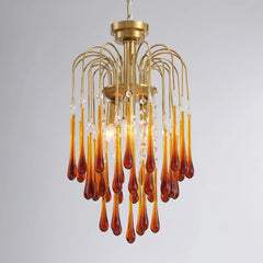 Modern brass chandelier with amber glass teardrop pendants and crystal accents from YhLamps