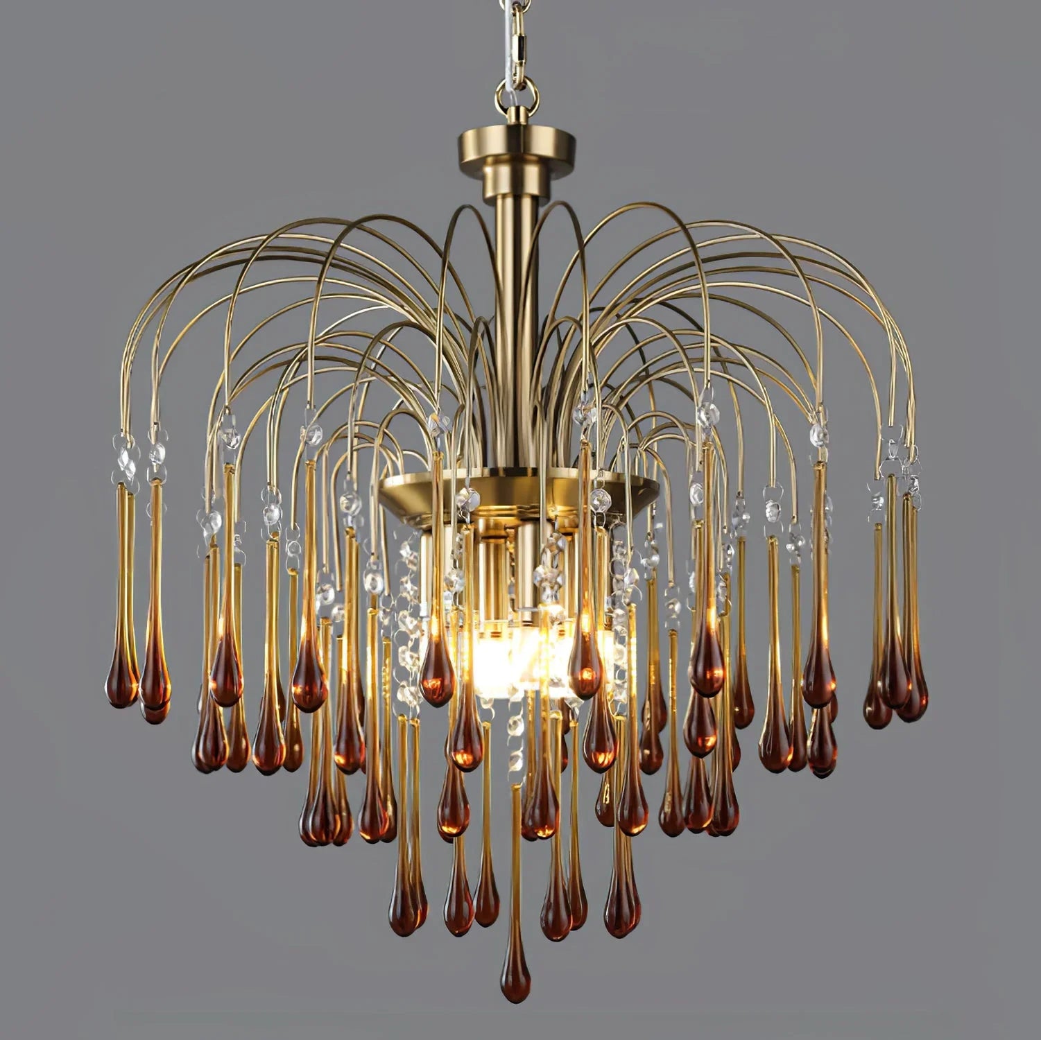 Modern brass chandelier with clear and amber glass teardrops pendant lamp on gray background