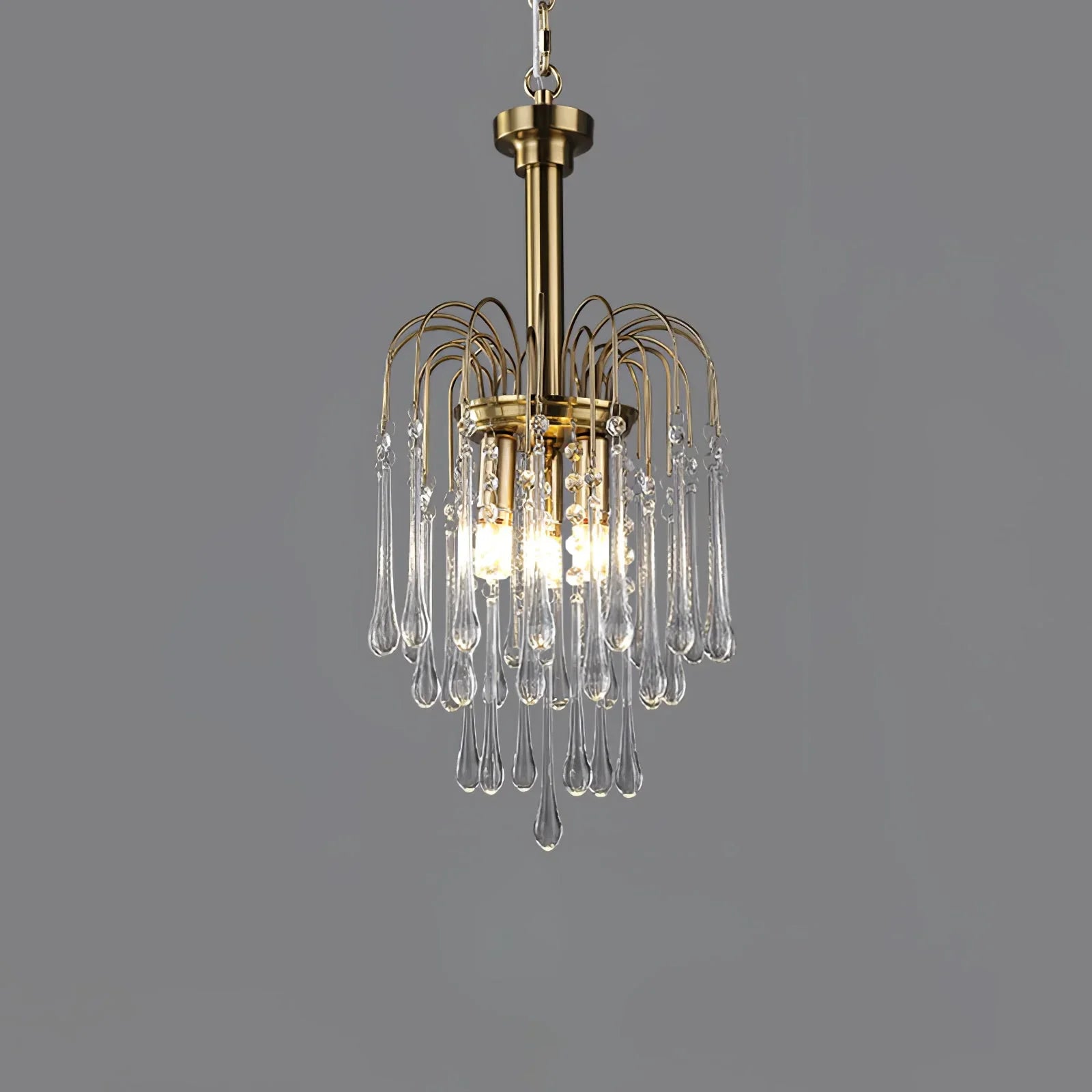 Modern brass pendant chandelier with hanging clear maltose glass drops and warm glowing bulbs