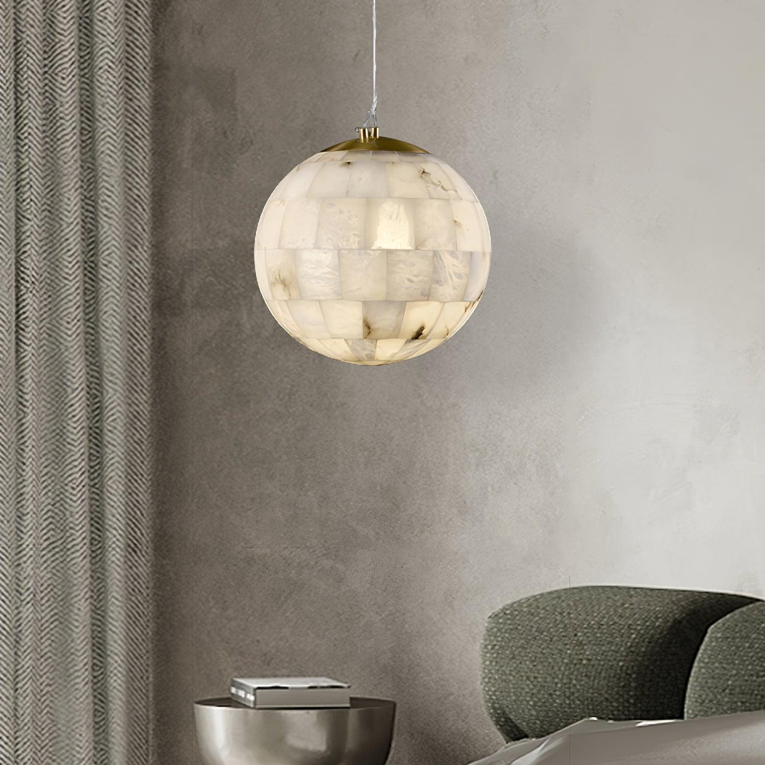 Modern alabaster ball pendant chandelier with brass top, hanging in minimalist living room