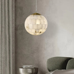 Modern alabaster ball pendant chandelier with brass top, hanging in minimalist living room