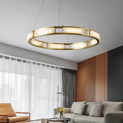 Modern brass and alabaster circular pendant chandelier with warm light in contemporary living room