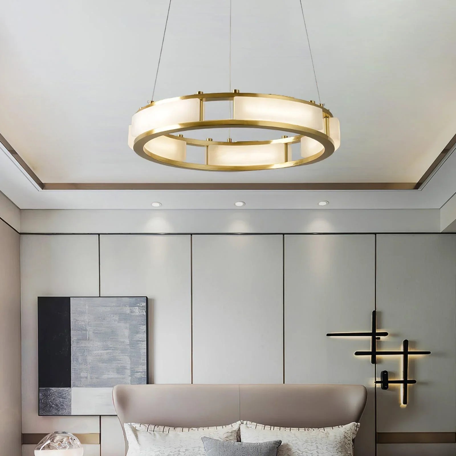 Modern brass and white alabaster circular pendant chandelier in elegant bedroom with minimalist wall lights