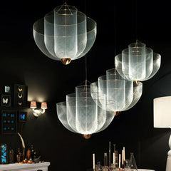 Modern pendant lamps with chrome body and gold base, warm light mesh design in elegant dark room