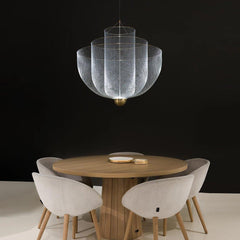Modern pendant lamp with chrome mesh and gold base hanging above wooden round table with beige upholstered chairs