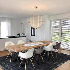 Modern dining room with a wooden table, mixed white and gray chairs, and a gold-based mesh pendant chandelier