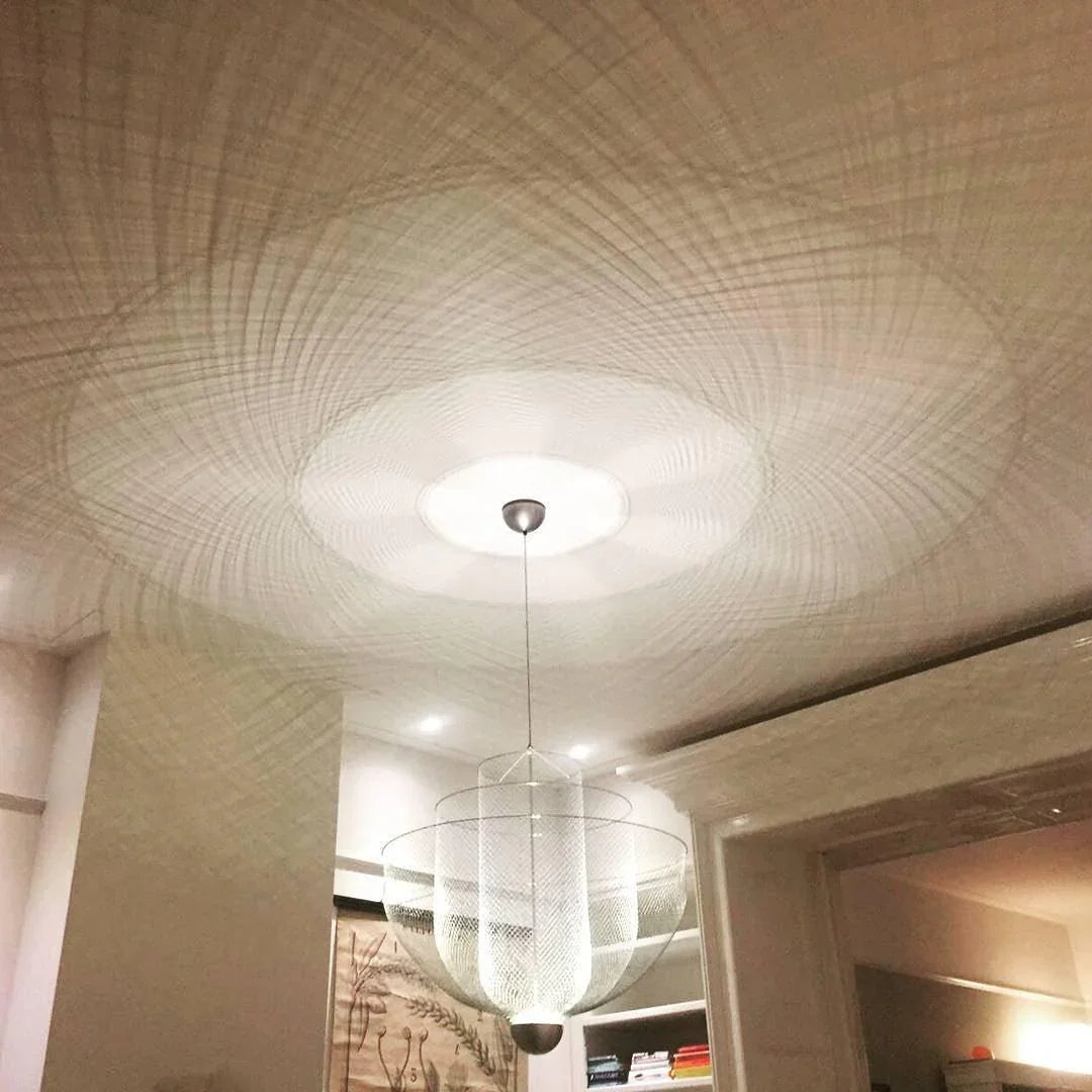 Modern YH Lamps pendant lamp with chrome body and gold base casting intricate warm light mesh shadows on ceiling