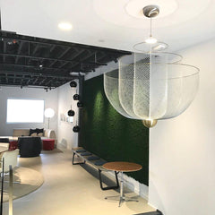 Modern living room with YH Lamps pendant lamp featuring a gold base and mesh design under warm light