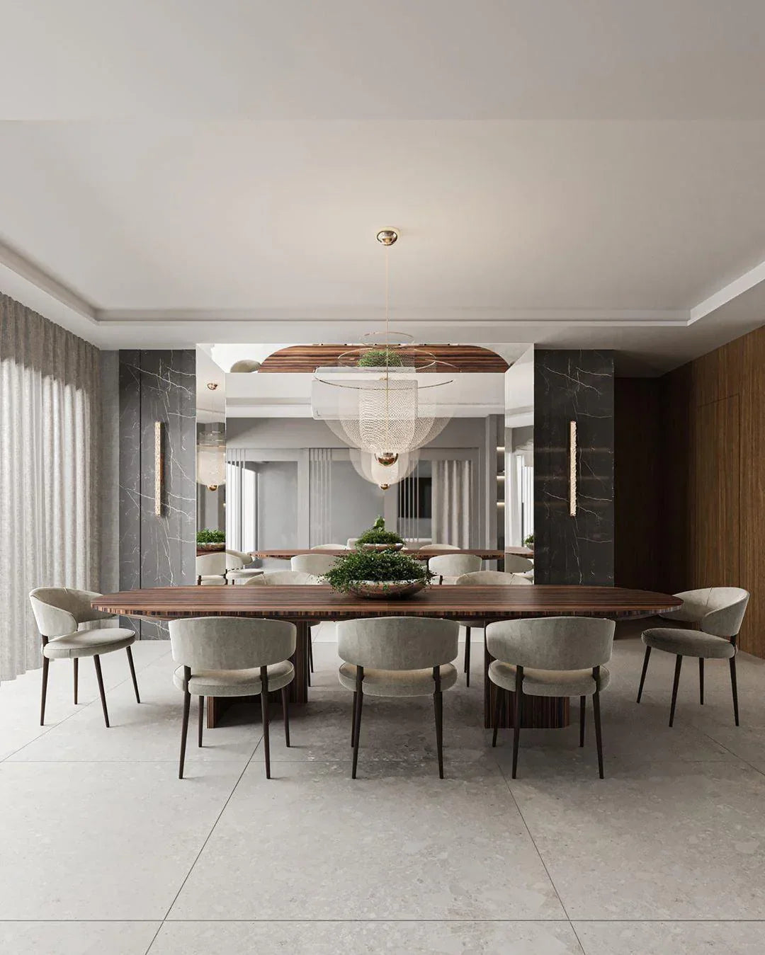 Modern dining room with large wooden table, eight gray upholstered chairs, chrome and gold pendant chandelier, gray marble walls, and large mirror