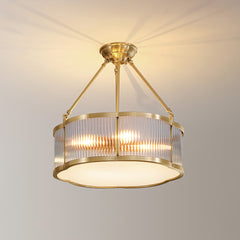 Modern brass pendant chandelier with glass panels by YH Lamps, glowing in a home interior
