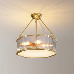 Modern brass pendant chandelier with glass panels by YH Lamps, glowing in a home interior