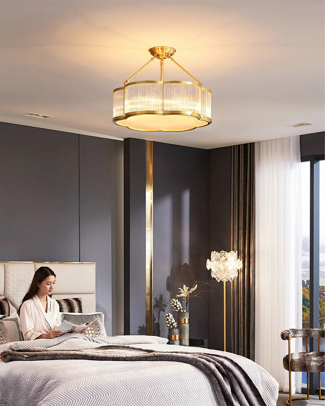 Modern brass pendant chandelier from YH Lamps illuminating a stylish bedroom interior