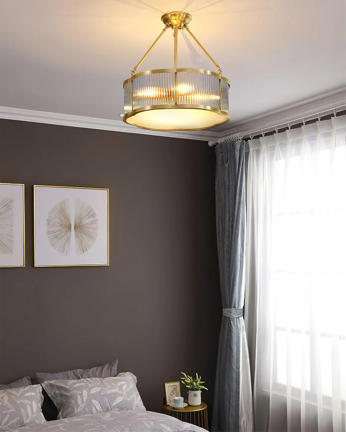 Modern brass pendant chandelier from YH Lamps in a stylish bedroom with grey walls and decor