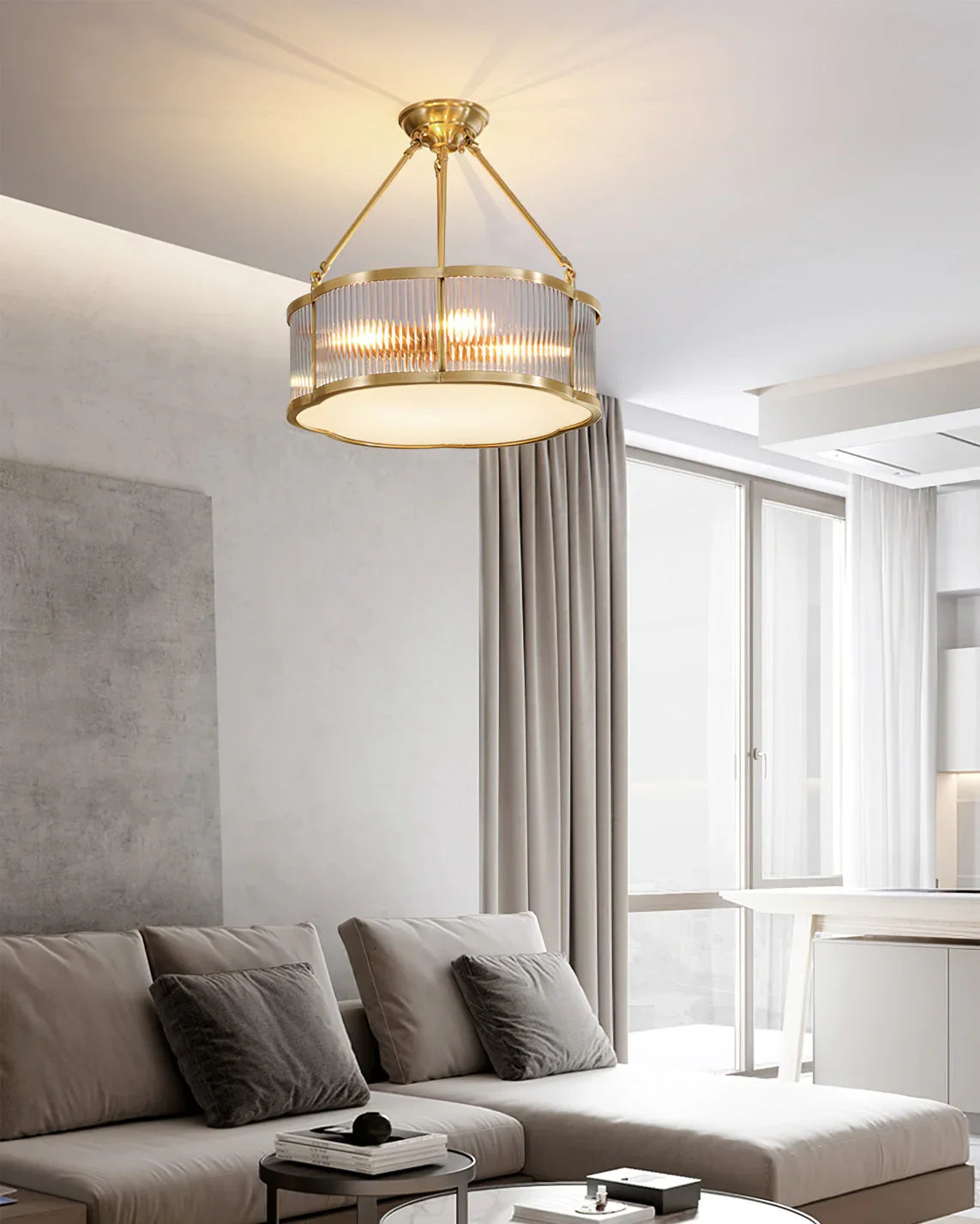 Modern brass pendant chandelier in a bright living room with neutral decor from YH Lamps