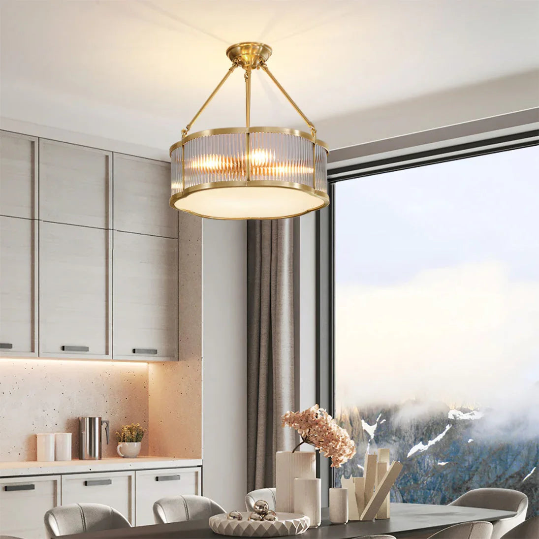 Modern brass pendant chandelier by YH Lamps in an elegant dining room with large window view.