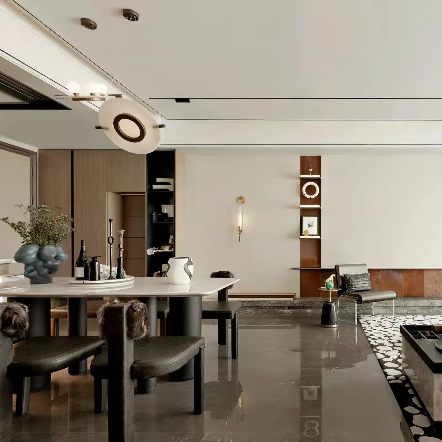 Modern dining room with white marble table, black chairs, designer pendant lamp, and minimalist decor