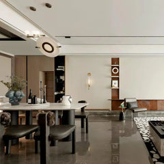 Modern dining room with white marble table, black chairs, designer pendant lamp, and minimalist decor