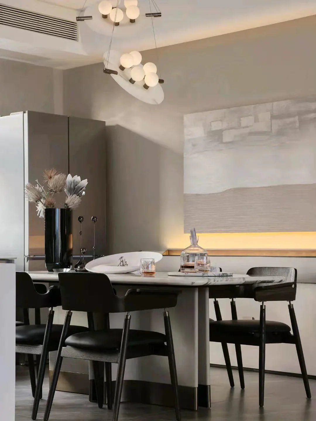 Modern dining room with black chairs, marble table, abstract wall art, and YH Lamps pendant lighting