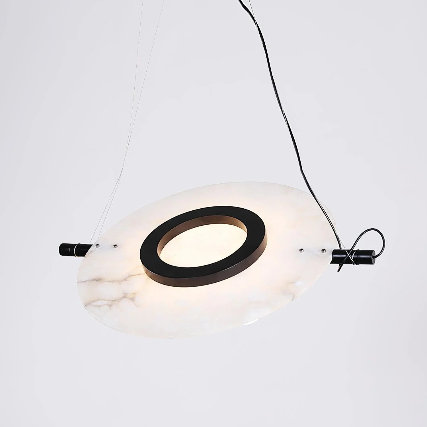 Modern circular pendant lamp with white marble texture and black ring detail suspended by wires