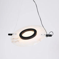 Modern circular pendant lamp with white marble texture and black ring detail suspended by wires