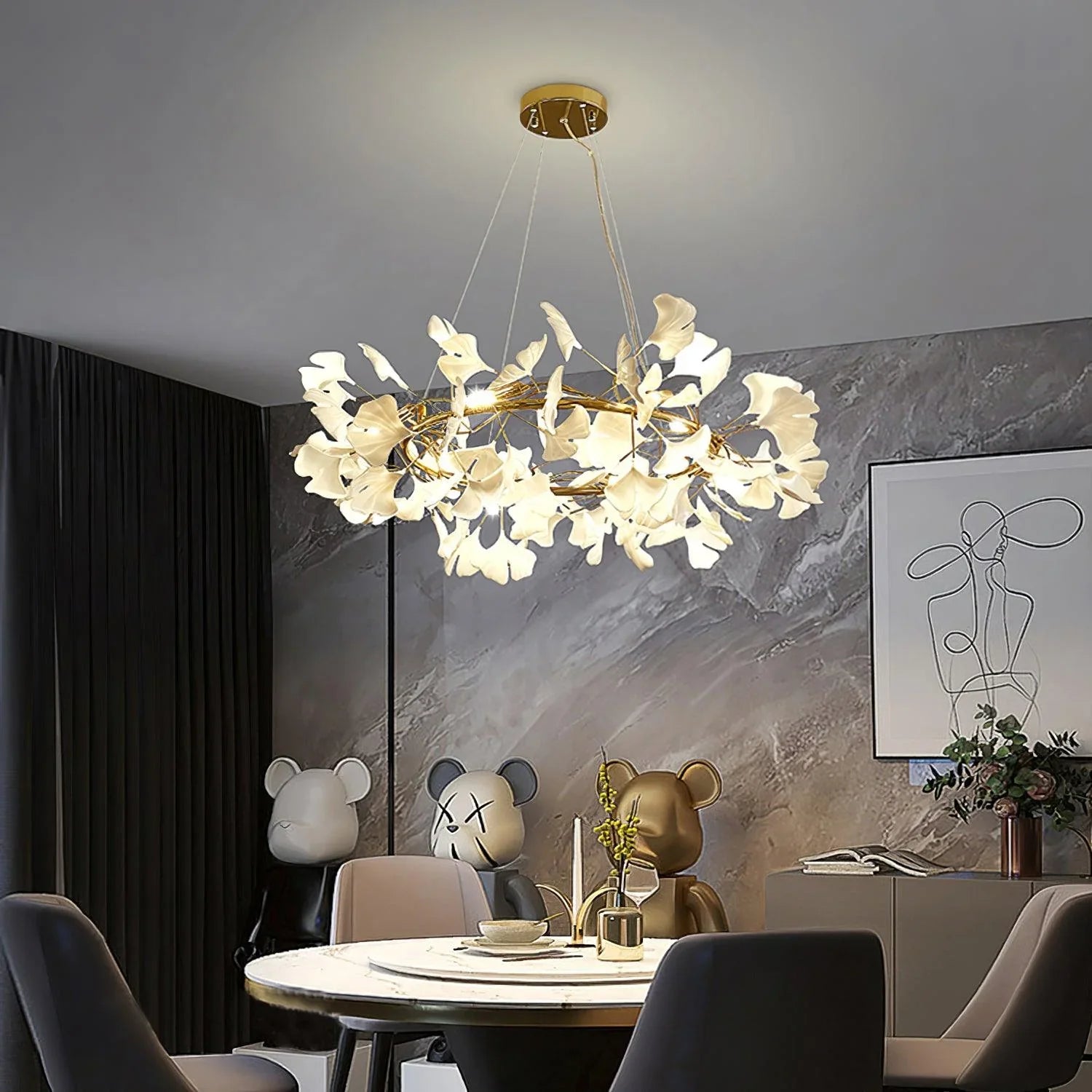 Modern gold and white ginkgo leaf chandelier pendant lamp above marble dining table in stylish room