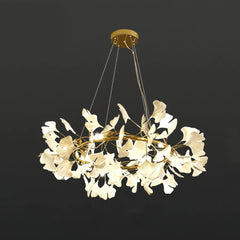 Modern gold and white ginkgo leaf chandelier pendant lamp with warm LED lighting suspended on wires