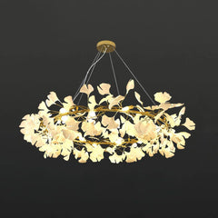 Modern gold and white gingko leaf chandelier pendant lamp with warm light, suspended by cables