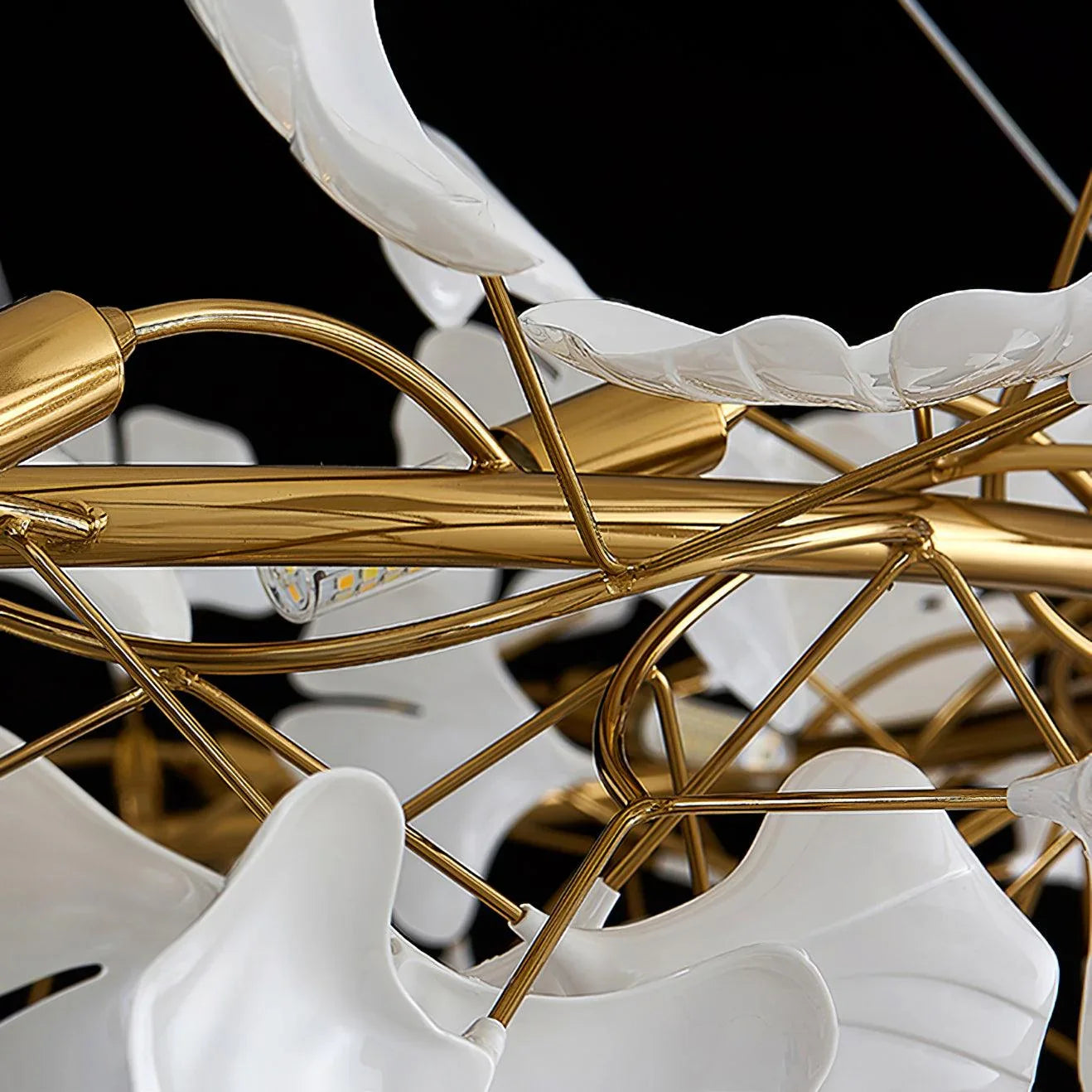 Close-up of modern gold and white gingko petal chandelier pendant lamp with intricate metal frame